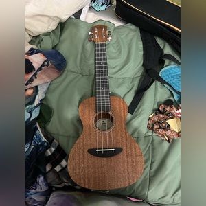 Ukulele included with a carrying case, extra strings, and a strap